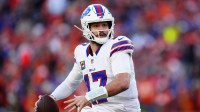 Buffalo Bills quarterback Josh Allen (17) rolls out during the second quarter of an AFC Divisional Round playoff game against the Denver Broncos at Empower Field at Mile High.