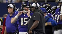 Baltimore Ravens quarterback Cooper Rush (15) talks with quarterbacks coach Tee Martin during the game between the Dallas Cowboys and the Baltimore Ravens at AT&T Stadium.