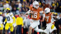 Texas Longhorns quarterback Arch Manning (16) rushes with the ball for a touchdown against the Michigan Wolverines during the second half at Camping World Stadium.