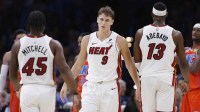 Miami Heat guard Davion Mitchell (45), guard Pelle Larsson (9), and center/forward Bam Adebayo (13) stand after a play against the Oklahoma City Thunder during the second half at Paycom Center.