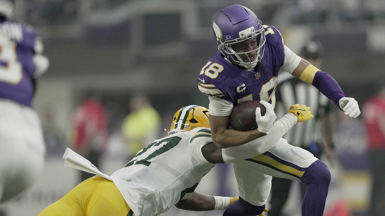 Minnesota Vikings wide receiver Justin Jefferson (18) is tackled by Green Bay Packers safety Kitan Oladapo (27) during the first quarter at U.S. Bank Stadium. 