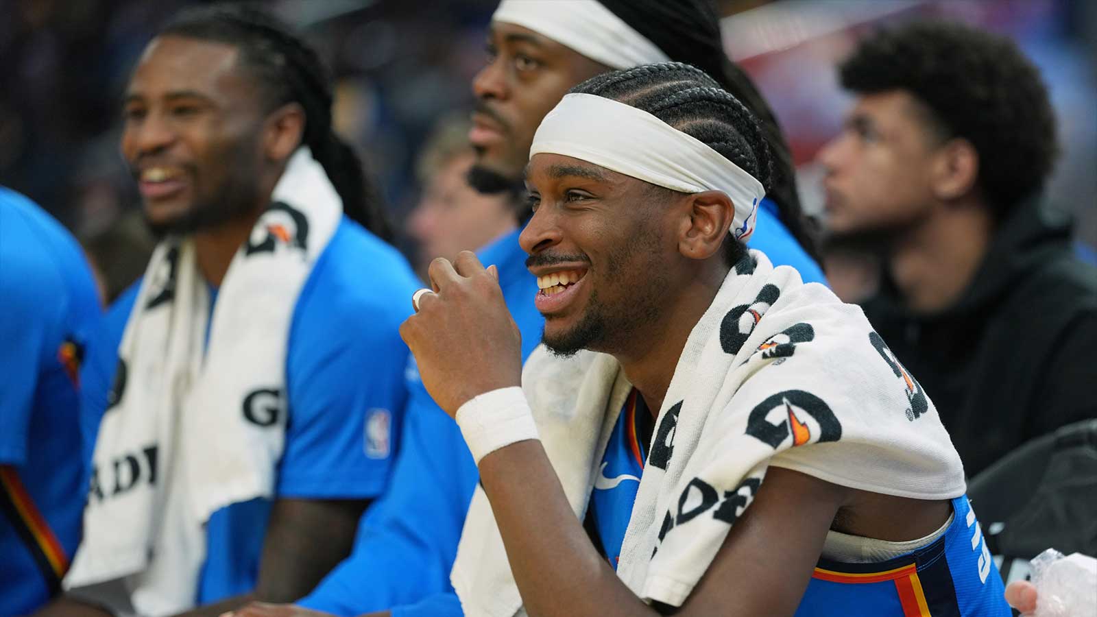 Thunder guard Shai Gilgeous-Alexander (center) sits on the bench during the second quarter against the Golden State Warriors at Chase Center