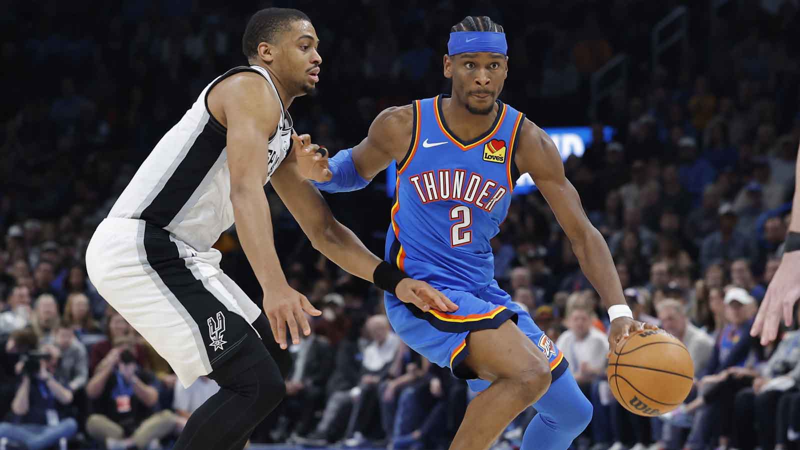 Thunder guard Shai Gilgeous-Alexander (2) drives down the court past San Antonio Spurs forward/guard Keldon Johnson (3) during the second half at Paycom Center