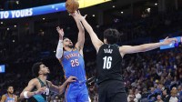 Thunder guard Ajay Mitchell (25) shoots over Portland Trail Blazers center Yang Hansen (16) during the second half at Paycom Center with Thunder coach Mark Daigneault in the background