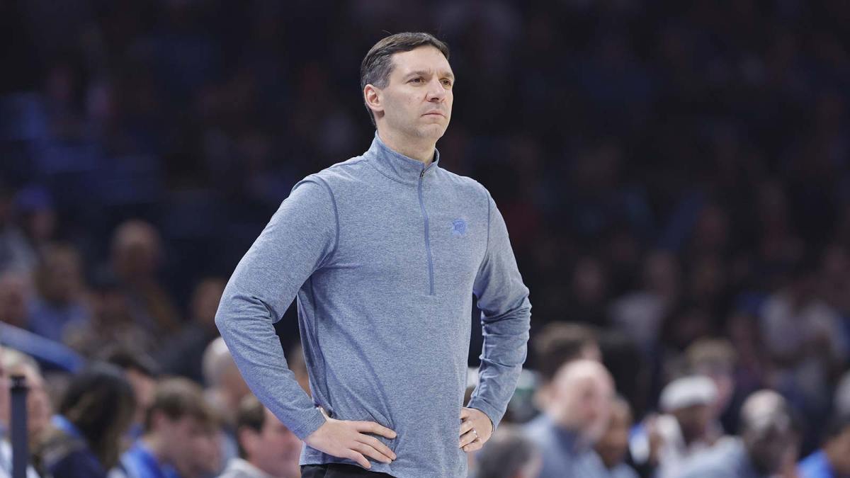 Thunder head coach Mark Daigneault watches his team play against the Charlotte Hornets during the second quarter at Paycom Center with the Timberwolves logo in the background
