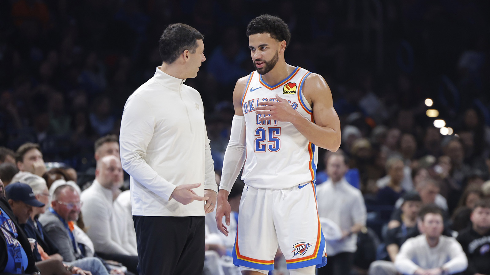 Thunder guard Ajay Mitchell (25) talks to Oklahoma City Thunder Head Coach Mark Daigneault during a break in play against the Utah Jazz during the second quarter at Paycom Center