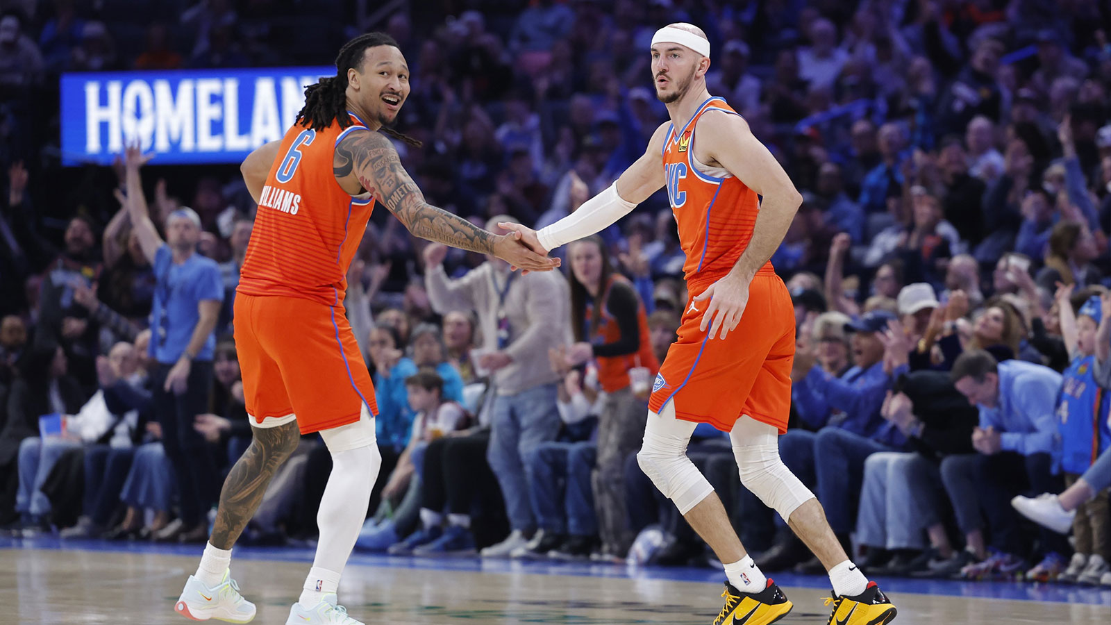 Thunder forward Jaylin Williams (6) and guard Alex Caruso (9) celebrate after scoring against the Miami Heat during the second half at Paycom Center