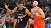 Spurs forward Keldon Johnson (3) reacts after scoring a three point basket ahead of Oklahoma City Thunder guard Alex Caruso (9) during the second half at Frost Bank Center