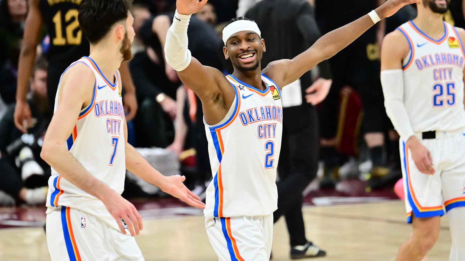 Thunder guard Shai Gilgeous-Alexander (2) and center Chet Holmgren (7) celebrate after a three point basket during the second half against the Cleveland Cavaliers at Rocket Arena