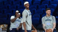 Thunder guard Luguentz Dort (5), guard Shai Gilgeous-Alexander (2) and center Isaiah Hartenstein (55) react during practice prior to the Emirates Cup semifinals at T-Mobile Arena with the Timberwolves logo in the background