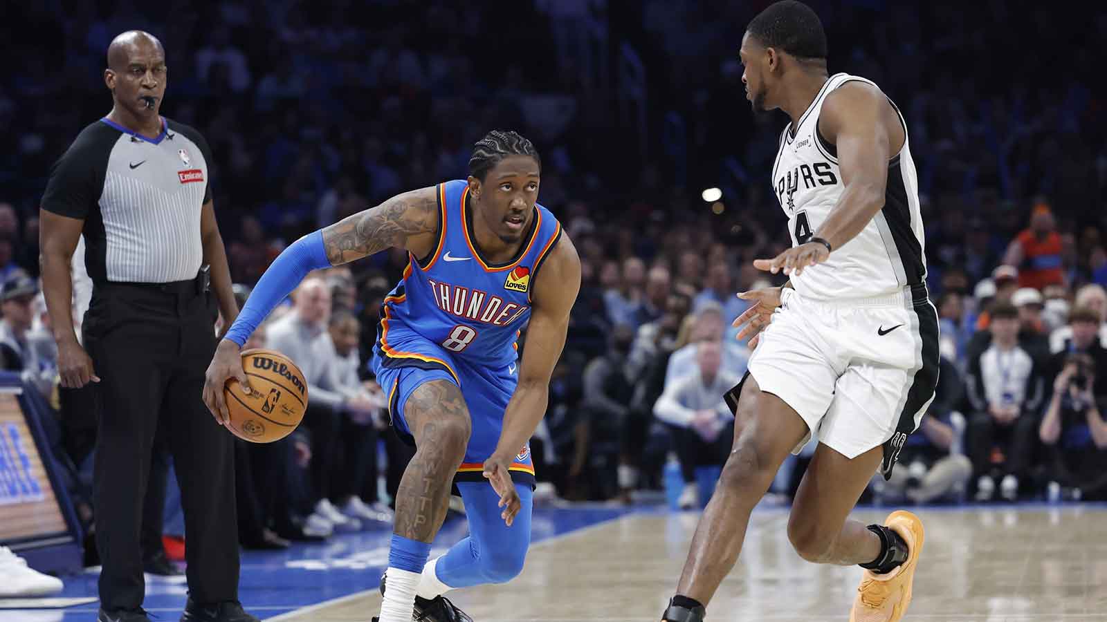 Thunder guard/forward Jalen Williams (8) drives down the court beside San Antonio Spurs guard De'aaron Fox (4) during the second half at Paycom Center