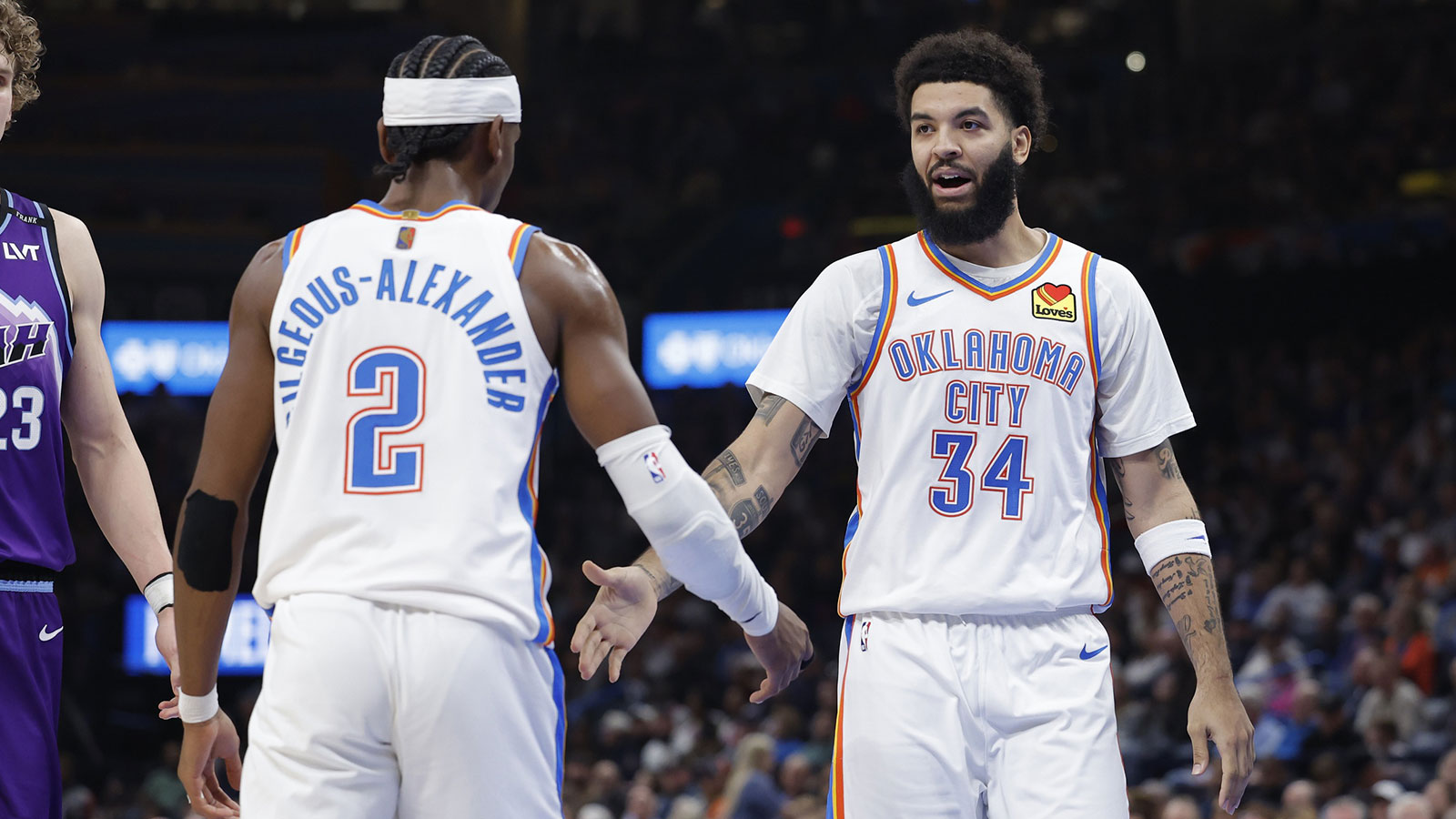 Thunder guard/forward Kenrich Williams (34) and Oklahoma City Thunder guard Shai Gilgeous-Alexander (2) celebrate after a play against the Utah Jazz during the second half at Paycom Center