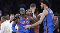 Thunder guard Luguentz Dort (5) walks away from a scuffle with New Orleans Pelicans guard Jeremiah Fears (0) during the second half at Paycom Center with Thunder coach Mark Daigneault in the background