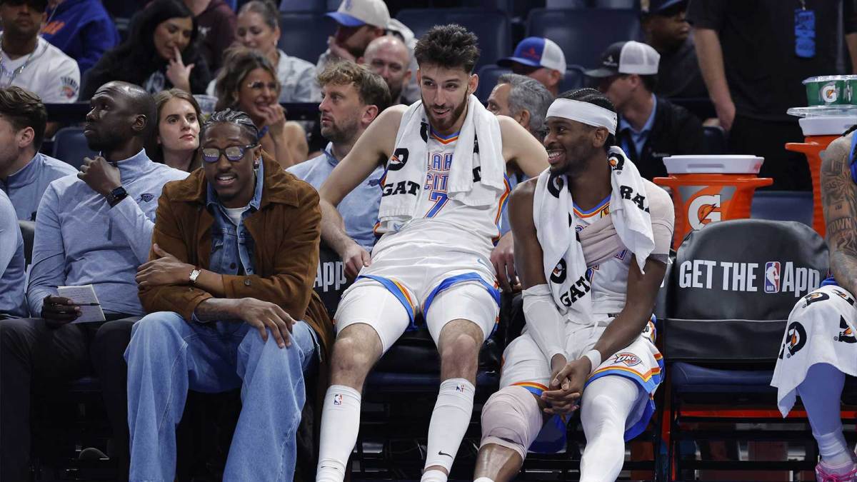 Thunder guard Jalen Williams (8), center Chet Holmgren (7), and guard Shai Gilgeous-Alexander (2) talk while sitting on the bench during the fourth quarter against the Los Angeles Lakers at Paycom Center with Michael Jordan and Stephen Curry in the background