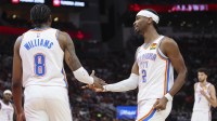 Thunder guard Jalen Williams (8) and guard Shai Gilgeous-Alexander (2) react after a play during the third quarter against the Houston Rockets at Toyota Center with Thunder head coach Mark Daigneault in the background