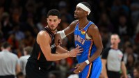 Suns guard Devin Booker (1) against Oklahoma City Thunder guard Shai Gilgeous-Alexander (2) in the second half at Mortgage Matchup Center