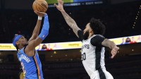 Thunder guard Shai Gilgeous-Alexander (2) shoots and scores a basket as San Antonio Spurs forward Julian Champagnie (30) defends during the second half at Paycom Center