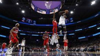 Timberwolves' Anthony Edwards drives vs. Wizards' Alex Sarr