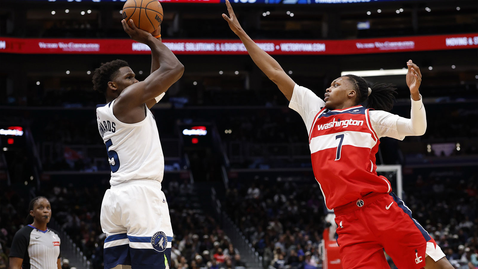 Minnesota Timberwolves guard Anthony Edwards (5) shoots the ball over Washington Wizards guard Bub Carrington (7) in the third quarter at Capital One Arena.