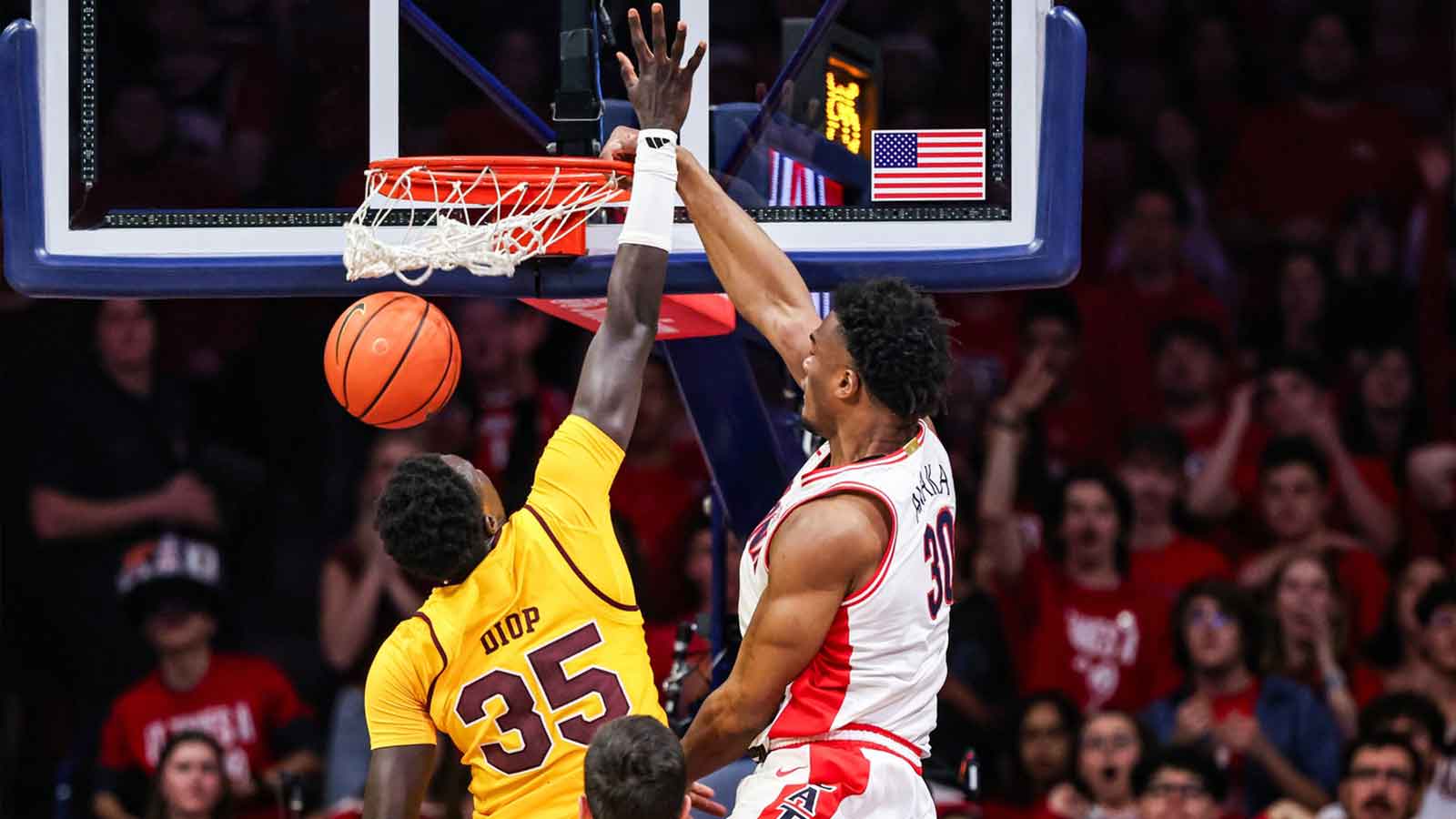 Arizona Wildcats forward Tobe Awaka (30) dunks the ball over Arizona State Sun Devils center Massamba Diop (35) during the first half of the game at McKale Memorial Center.