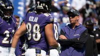 Baltimore Ravens offensive coordinator Todd Monken speaks with members of the offense before the game against the Las Vegas Raiders at M&T Bank Stadium.