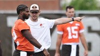Cleveland Browns quarterback Shedeur Sanders (12) talks to Cleveland Browns offensive coordinator Tommy Rees during minicamp at CrossCountry Mortgage Campus.