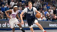 Dallas Mavericks forward Cooper Flagg (32) drives to the basket past Philadelphia 76ers guard Vj Edgecombe (77) during the first quarter at the American Airlines Center.