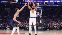 New York Knicks center Karl-Anthony Towns (32) shoots past Dallas Mavericks forward Dwight Powell (7) in the first quarter at Madison Square Garden.