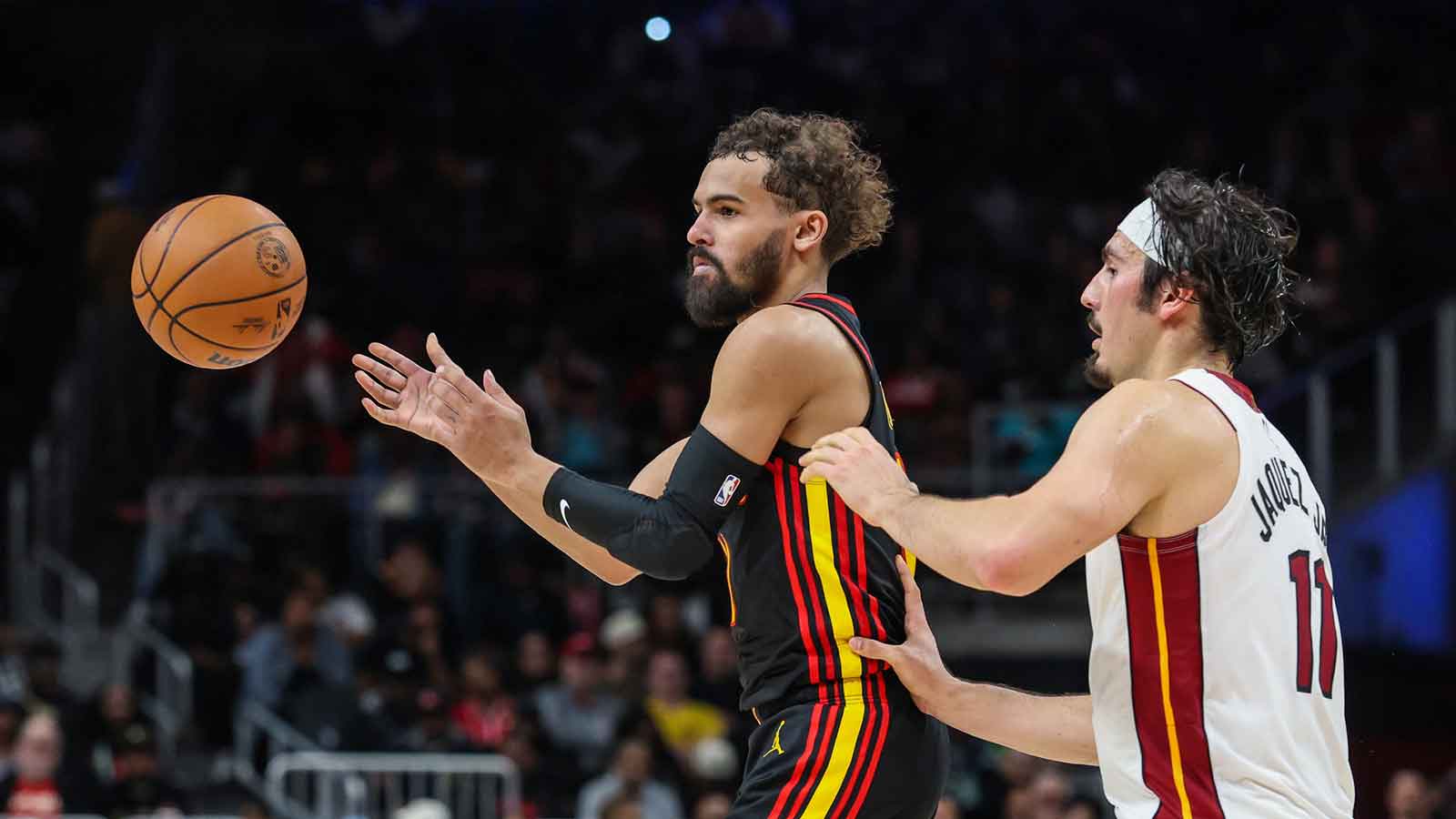 Atlanta Hawks guard Trae Young (11) makes a pass against Miami Heat forward Jaime Jaquez Jr. (11) during the fourth quarter at State Farm Arena.