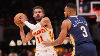 Atlanta Hawks guard Trae Young (11) is defended by New Orleans Pelicans guard CJ McCollum (3) in the second quarter at State Farm Arena.