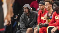 Atlanta Hawks injured player Trae Young (center in hoodie) on the bench during the game against the Minnesota Timberwolves during the second half at State Farm Arena.