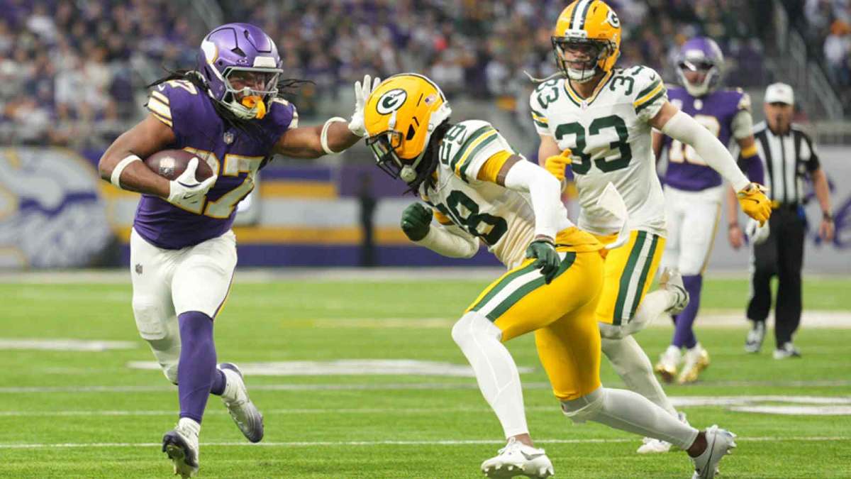 Jan 4, 2026; Minneapolis, Minnesota, USA; Minnesota Vikings running back Jordan Mason (27) runs the ball against Green Bay Packers cornerback Trevon Diggs (28) during the second quarter at U.S. Bank Stadium. Mandatory Credit: Matt Blewett-Imagn Images
