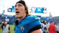 Jacksonville Jaguars quarterback Trevor Lawrence (16) looks to congratulate other Buffalo Bills players after the game of an NFL football AFC Wild Card playoff matchup.