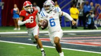 Mississippi Rebels quarterback Trinidad Chambliss (6) scrambles with the ball under pressure from Georgia Bulldogs defensive back Daylen Everette (6) in the fourth quarter during the 2025 Sugar Bowl and quarterfinal game of the College Football Playoff at Caesars Superdome. Mandatory Credit: Geoff Burke-Imagn Images