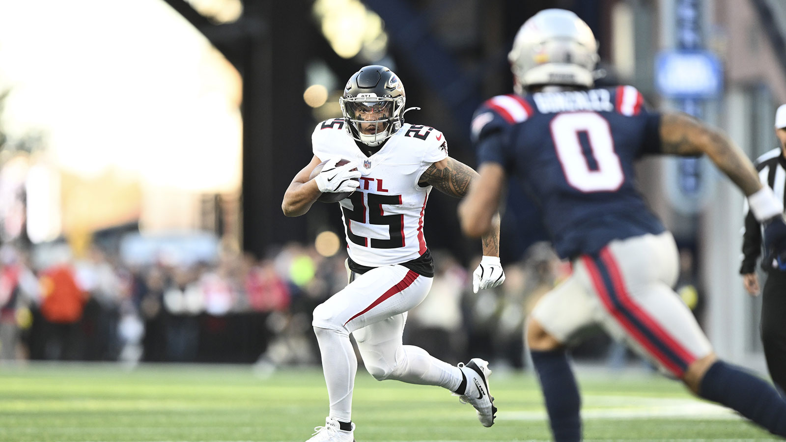 Atlanta Falcons running back Tyler Allgeier (25) runs the ball against New England Patriots cornerback Christian Gonzalez (0) during the third quarter at Gillette Stadium.