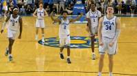 UCLA Bruins guard Eric Dailey Jr. (3), guard Trent Perry (0), guard Donovan Dent (2) and forward Xavier Booker (1) celebrate after a 3-point basket by forward Tyler Bilodeau (34) in the final seconds of the game against the Purdue Boilermakers in the second half at Pauley Pavilion presented by Wescom Financial.