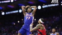 Philadelphia 76ers guard VJ Edgecombe (77) drives for a dunk in front of Toronto Raptors forward Brandon Ingram (3) during the second quarter at Xfinity Mobile Arena.