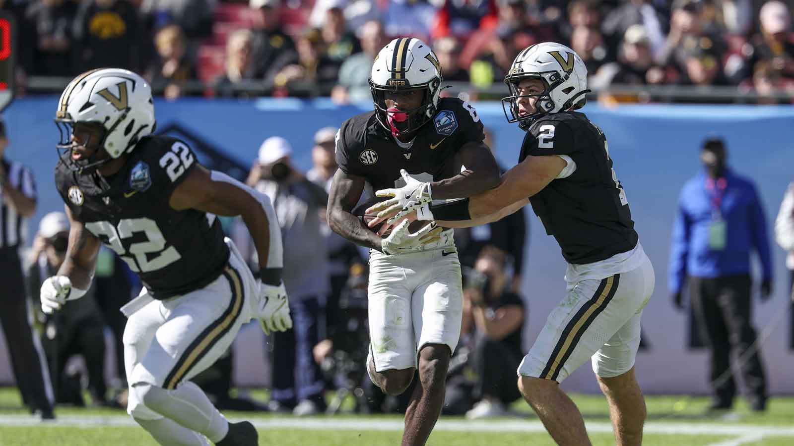 Vanderbilt Commodores quarterback Diego Pavia (2) hands off to wide receiver Tre Richardson (6) against the Iowa Hawkeyes in the second quarter during the ReliaQuest Bowl at Raymond James Stadium.