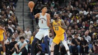San Antonio Spurs center Victor Wembanyama (1) handles the ball in front of Los Angeles Lakers forward LeBron James (23) in the second half at Frost Bank Center.