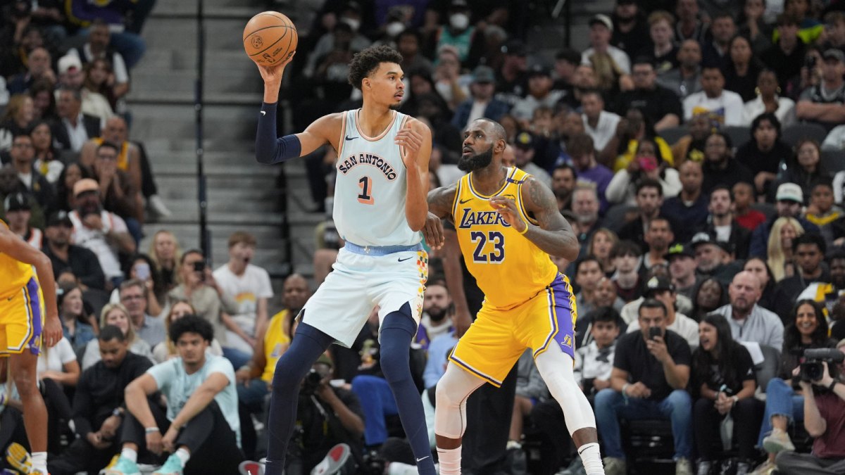 San Antonio Spurs center Victor Wembanyama (1) handles the ball in front of Los Angeles Lakers forward LeBron James (23) in the second half at Frost Bank Center.