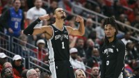 San Antonio Spurs forward Victor Wembanyama (1) and guard Stephon Castle (5) react after a play during the fourth quarter against the Houston Rockets at Toyota Center.