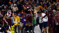 Virginia Tech Hokies linebacker Caleb Woodson (20) celebrates after a play during the second quarter against the Virginia Cavaliers at Lane Stadium.