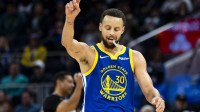 Warriors guard Stephen Curry (30) reacts during the third quarter against the Utah Jazz at Chase Center with Dell Curry in the background