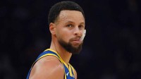 Warriors guard Stephen Curry (30) waits for play to resume against the Portland Trail Blazers in the first quarter at Chase Center with Kendrick Perkins in the background