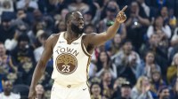 Warriors forward Draymond Green (23) reacts after hitting a three-point shot against the Charlotte Hornets during the first quarter at Chase Center with the Heat logo in the background
