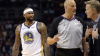 Warriors forward center DeMarcus Cousins (0) looks on as head coach Steve Kerr and an official discuss a technical foul called during the second half against the Charlotte Hornets at the Spectrum Center. Warriors won 121-110