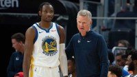 Warriors head coach Steve Kerr (right) talks to forward Jonathan Kuminga (00) during the third quarter against the San Antonio Spurs at Chase Center
