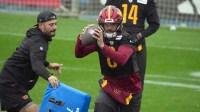Washington Commanders quarterback Marcus Mariota (8) works with assistant quarterbacks coach David Blough during practice at Ciudad Deportiva del Real Madrid.