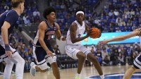 BYU Cougars forward AJ Dybantsa (3) controls the ball while being defended by Arizona Wildcats forward Koa Peat (10) during the first half at Marriott Center.
