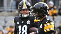 Pittsburgh Steelers quarterback Will Howard (18) talks with quarterback Aaron Rodgers (8) before the game against the Cincinnati Bengals at Acrisure Stadium.